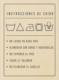 Etiqueta de instrucciones de cuido de prenda con símbolos de lavado y advertencias en español